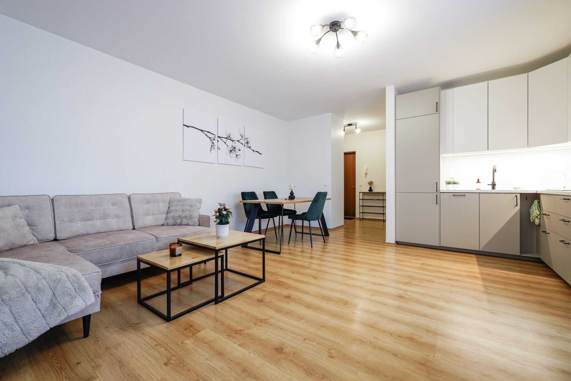 Modern open plan living room and kitchen at Kuressaare Stays apartment in Kuressaare